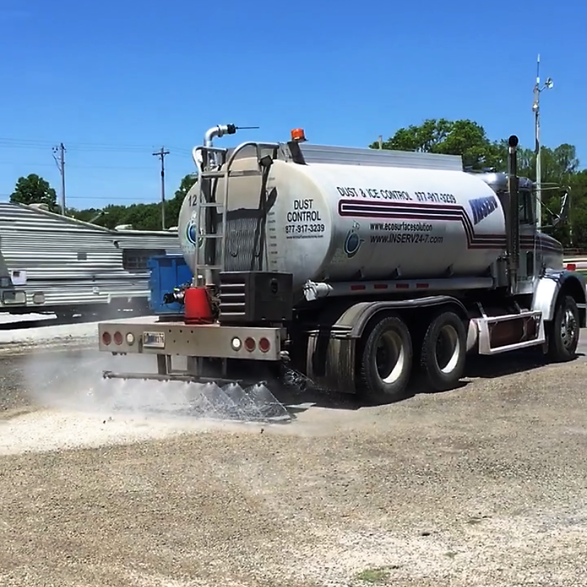 Dust Control truck spraying magnesium chloride on dirt to control dust