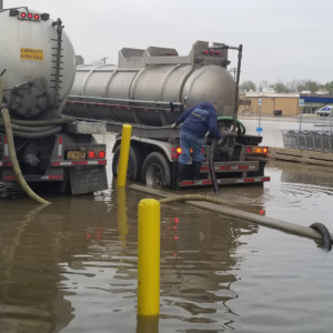 Water vac cleaning up large flood in parking lot